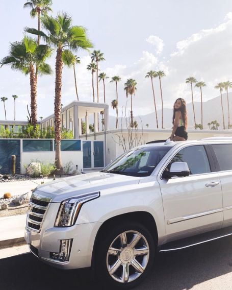 Izabella Alvarez with her Cadillac Escalade car